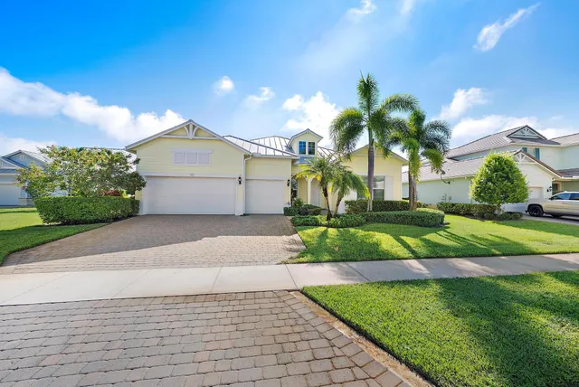 a front view of a house with a yard and a garage