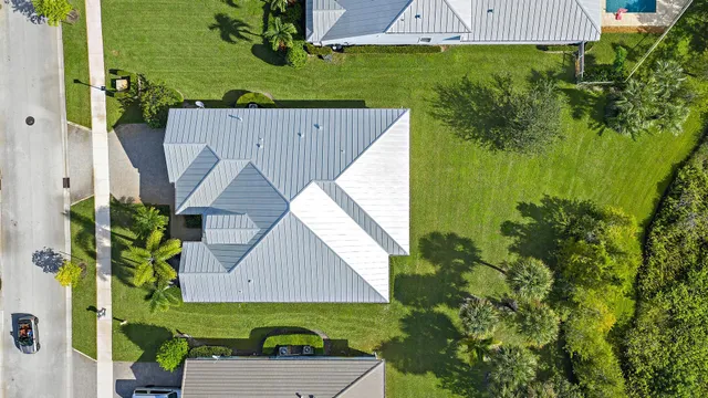 an aerial view of a house with a yard