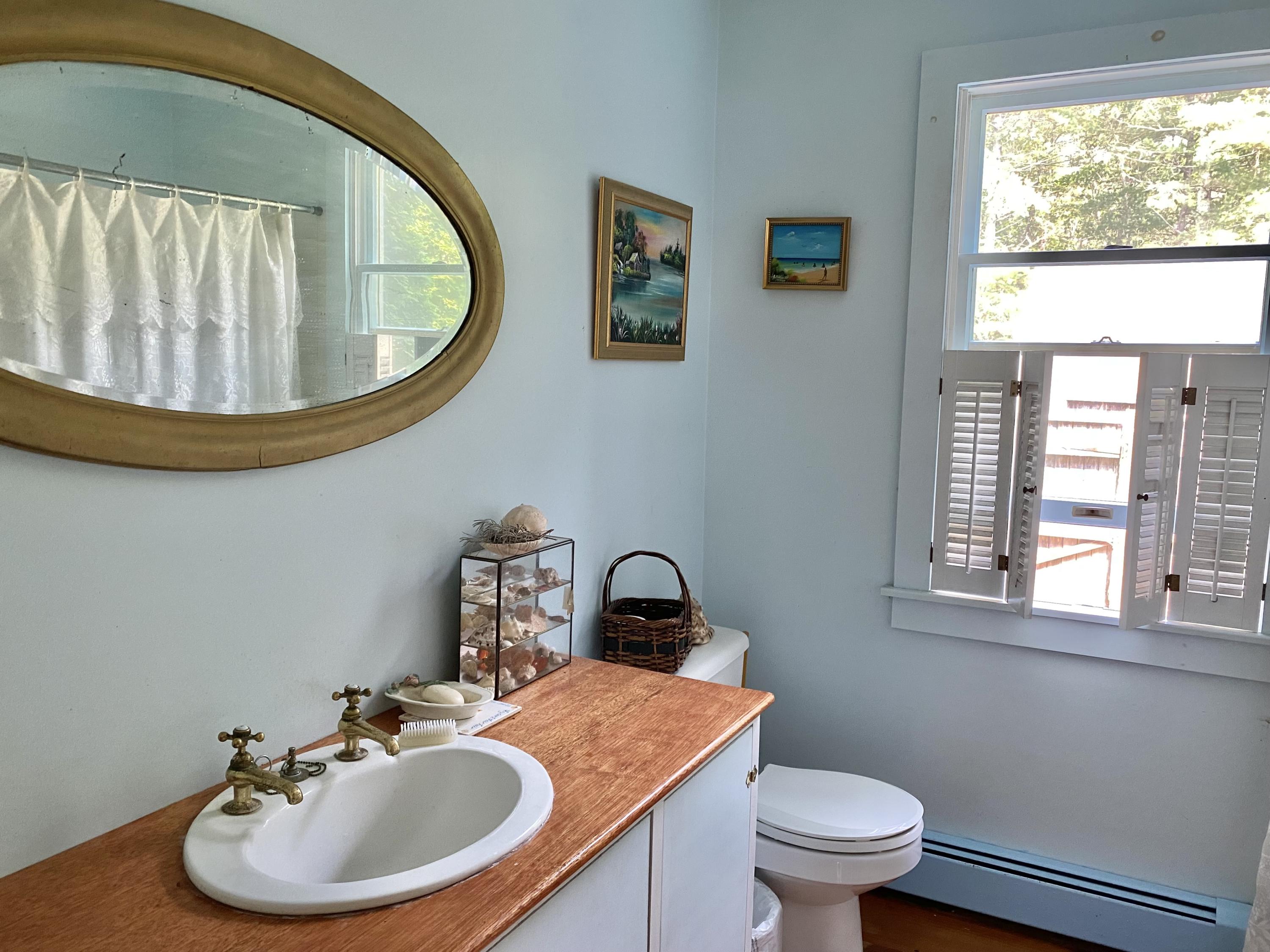 190 Little River Road Cotuit, MA 02635 - Photo 11 of 23 a bathroom with a toilet a sink and a mirror