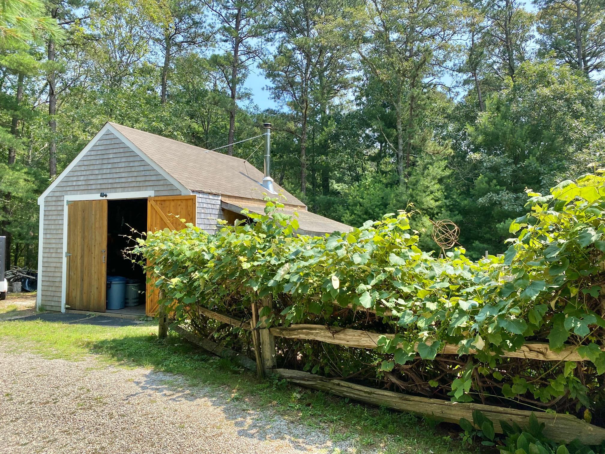 190 Little River Road Cotuit, MA 02635 - Photo 20 of 23 a front view of a house with a garden