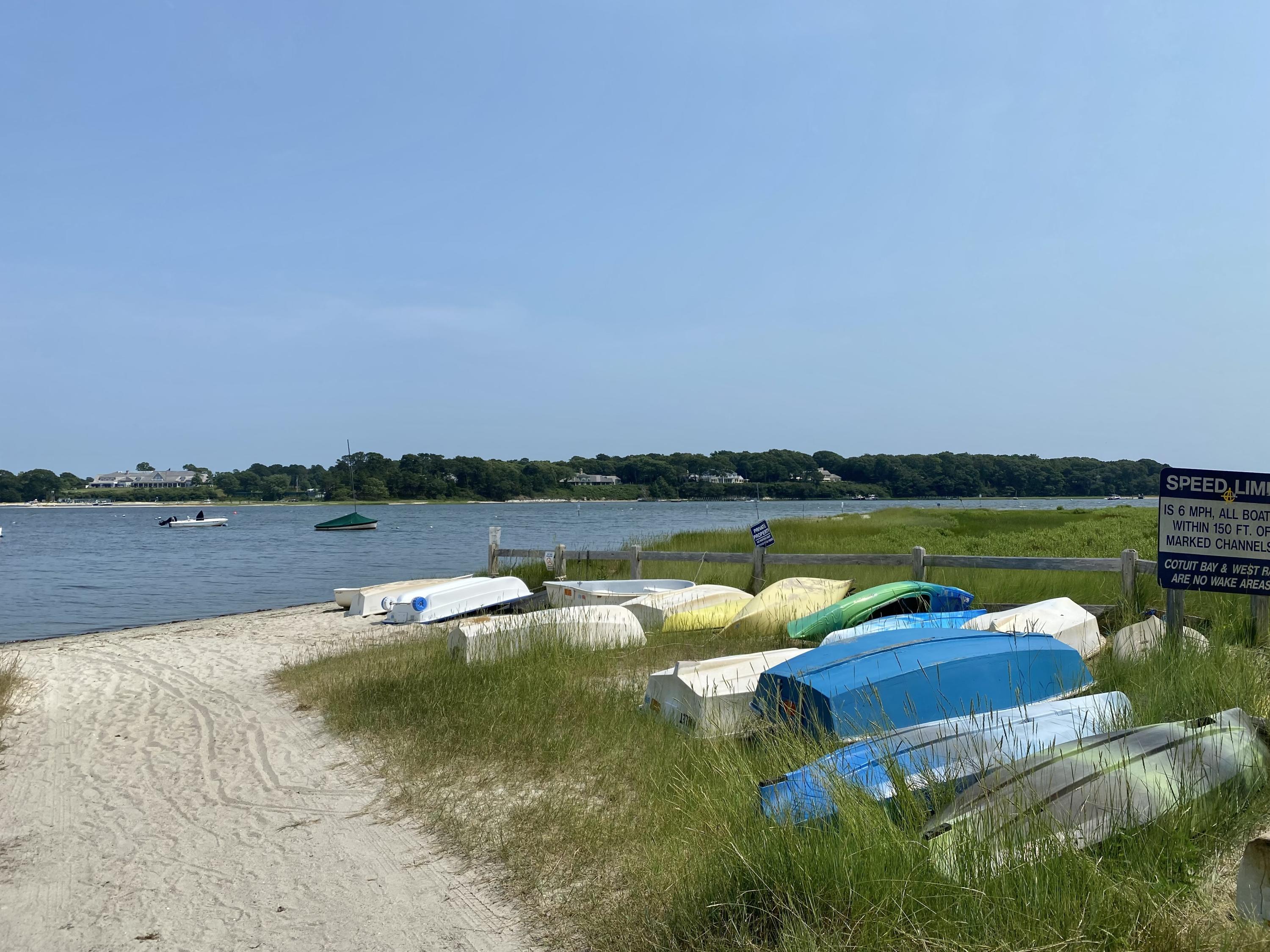 190 Little River Road Cotuit, MA 02635 - Photo 2 of 23 a view of a lake with houses in the background