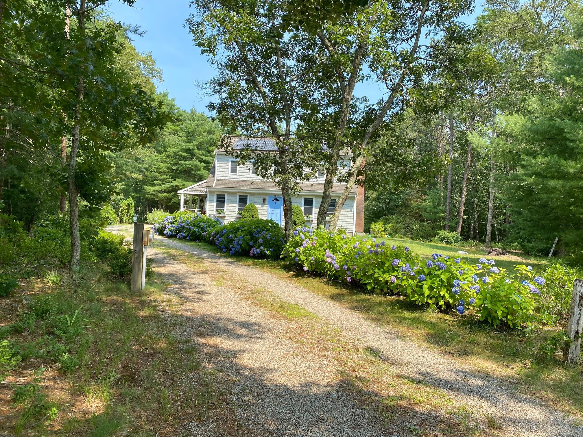 190 Little River Road Cotuit, MA 02635 - Photo 22 of 23 a house with trees in front of it