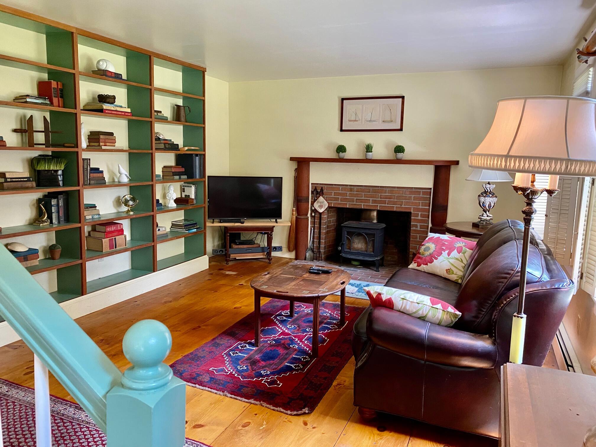 190 Little River Road Cotuit, MA 02635 - Photo 7 of 23 a living room with furniture and a fireplace