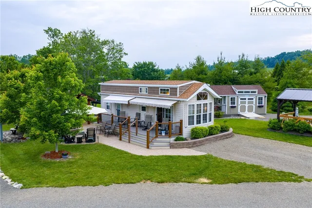 a view of a house with a yard and sitting area