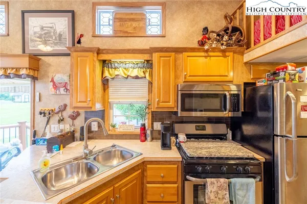 a kitchen with a stove a sink and a refrigerator