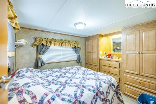 a bedroom with a bed and a dresser