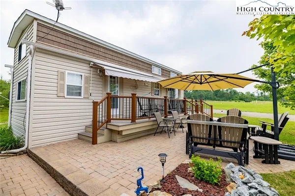 a roof deck with a table and chairs under an umbrella