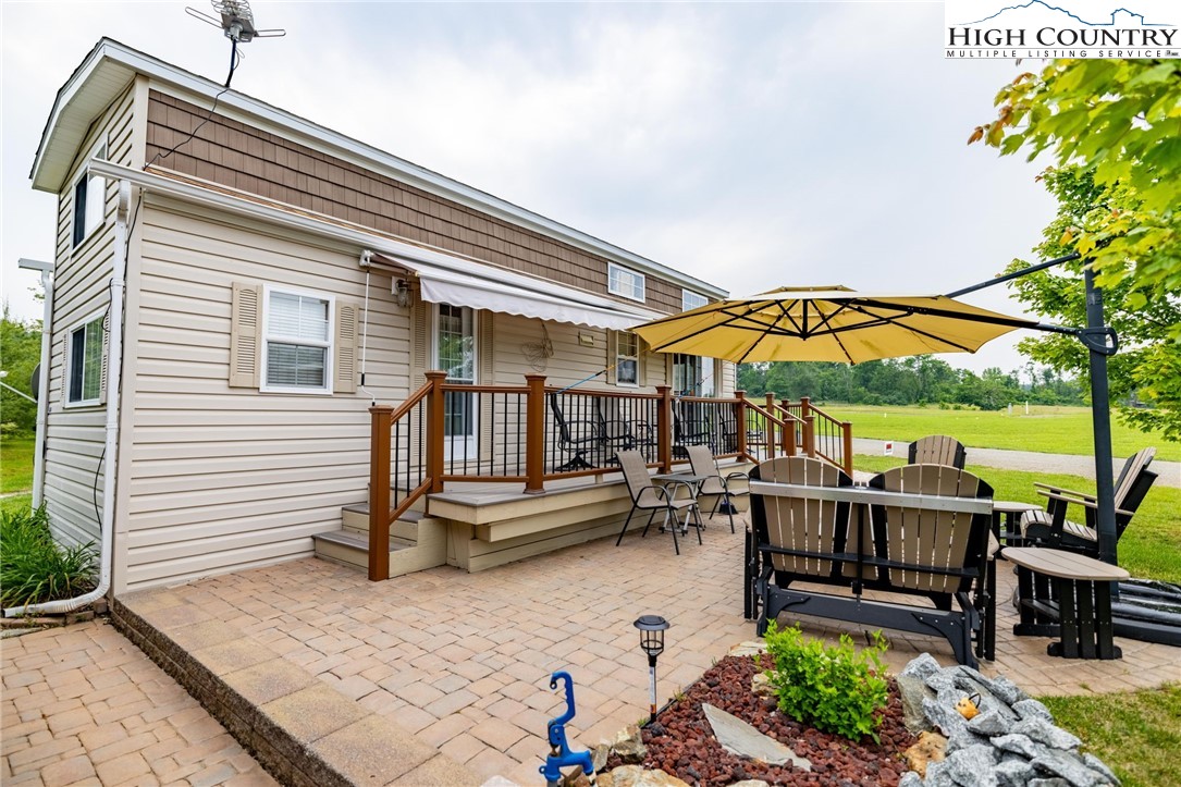 2330 Edmonds Road Galax, VA 24333 - Photo 22 of 42 a roof deck with a table and chairs under an umbrella