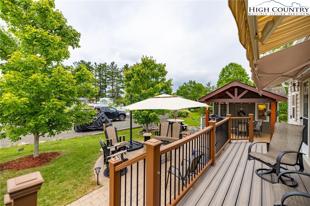 2330 Edmonds Road Galax, VA 24333 - Photo 23 of 42 a view of a deck with a table and chairs under an umbrella with wooden fence