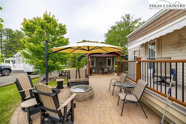 a view of backyard with outdoor seating and trees