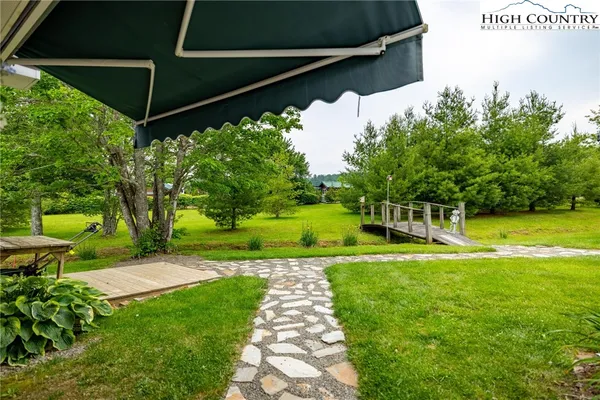 a view of a backyard with swimming pool