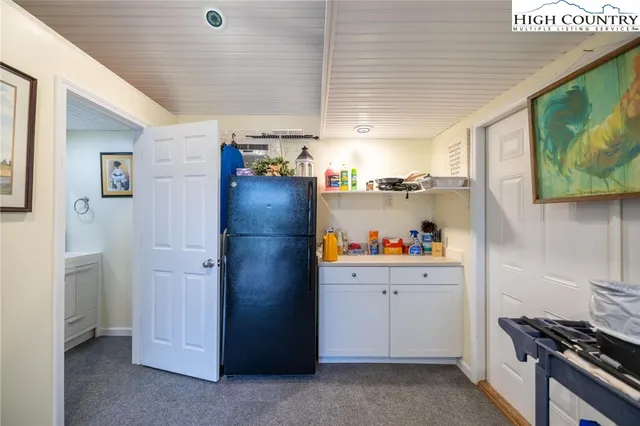 a kitchen with refrigerator and cabinets