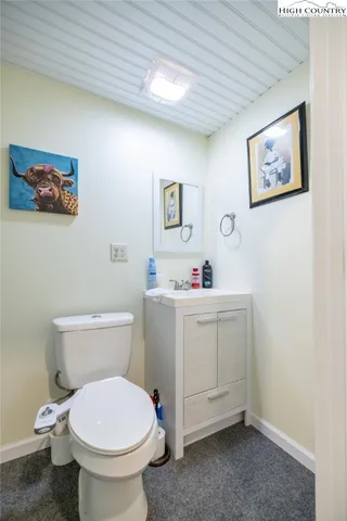 a bathroom with a toilet sink and vanity