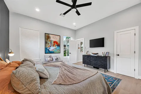 a bedroom with furniture and a ceiling fan