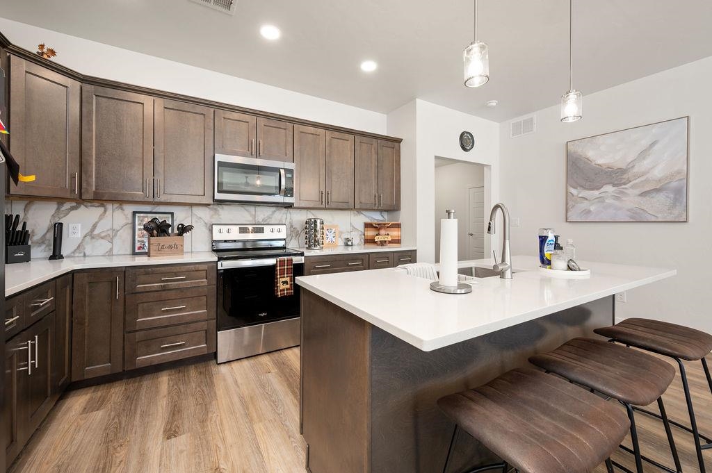 1694 Tungsten Way Fruita, CO 81521 - Photo 14 of 22 a kitchen with a sink a stove and cabinets