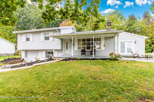 a front view of a house with a garden and patio