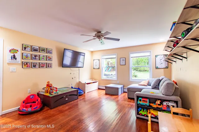 a view of backyard with swimming pool and green space