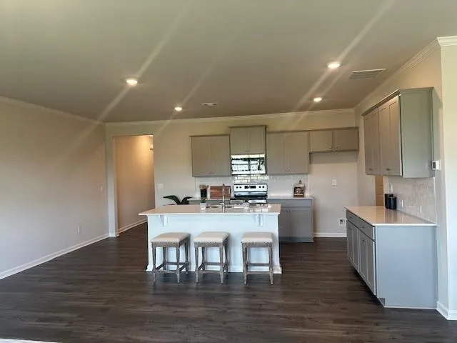 a kitchen with a sink cabinets and wooden floor