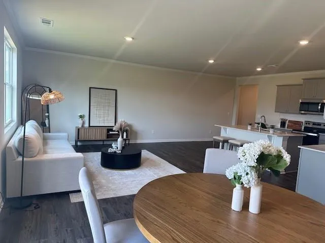 a dining room with furniture and wooden floor