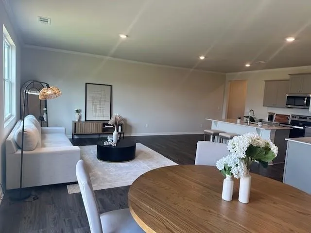 a kitchen with a dining table wooden floor and mirrors
