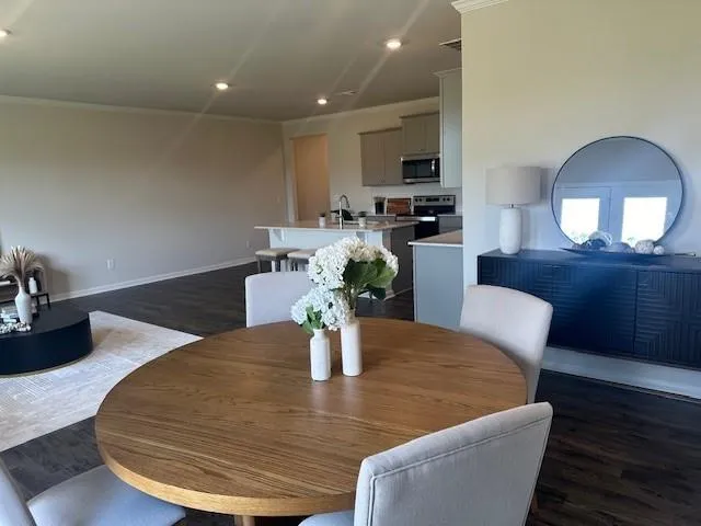 a dining room with furniture and wooden floor