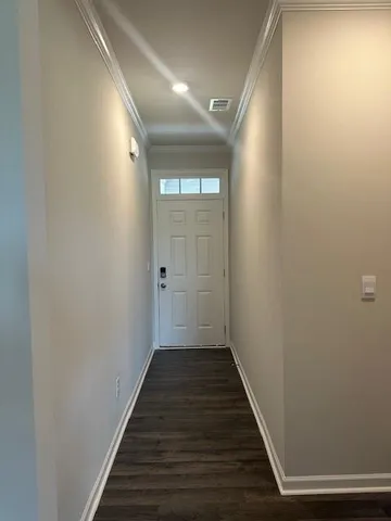 a view of a hallway with wooden floor