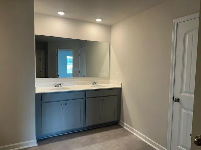 a bathroom with a shower sink and mirror
