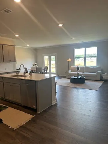 a kitchen with sink refrigerator and cabinets