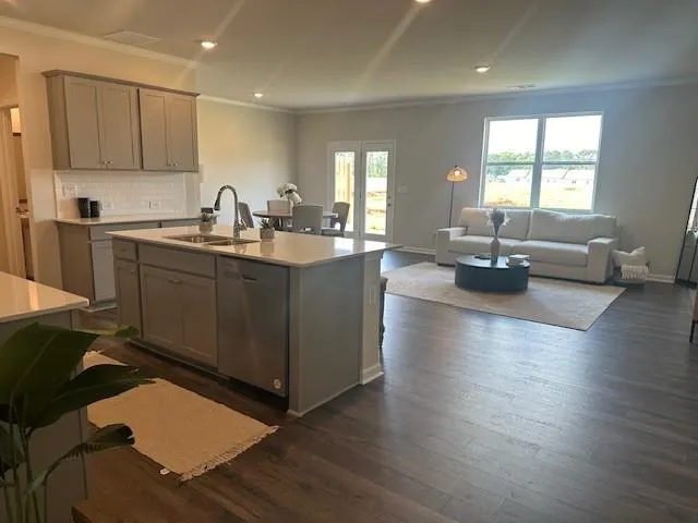 a kitchen with sink refrigerator and cabinets