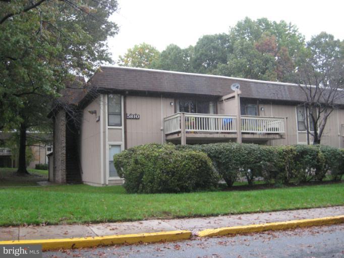 5810 Royal Ridge Drive, Unit O Springfield, VA 22152 - Photo 6 of 6 a front view of a house with a garden