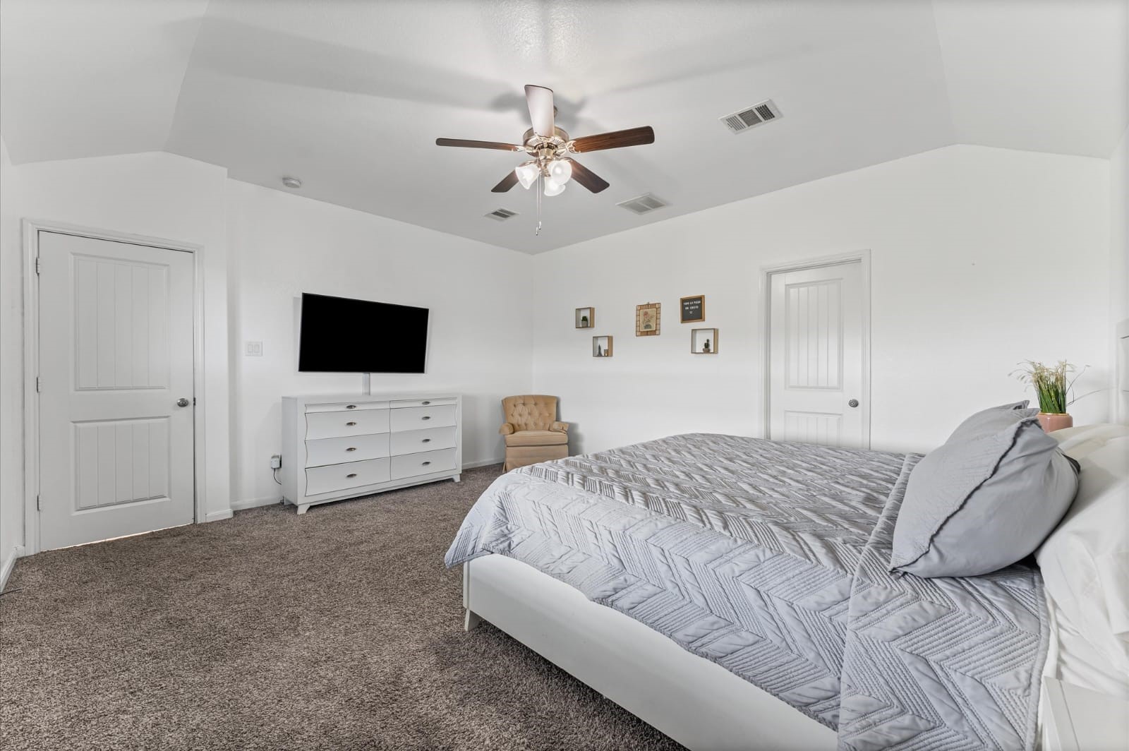 3007 Magellan Ridge Lane Baytown, TX 77521 - Photo 16 of 34 a spacious bedroom with a bed and a flat screen tv