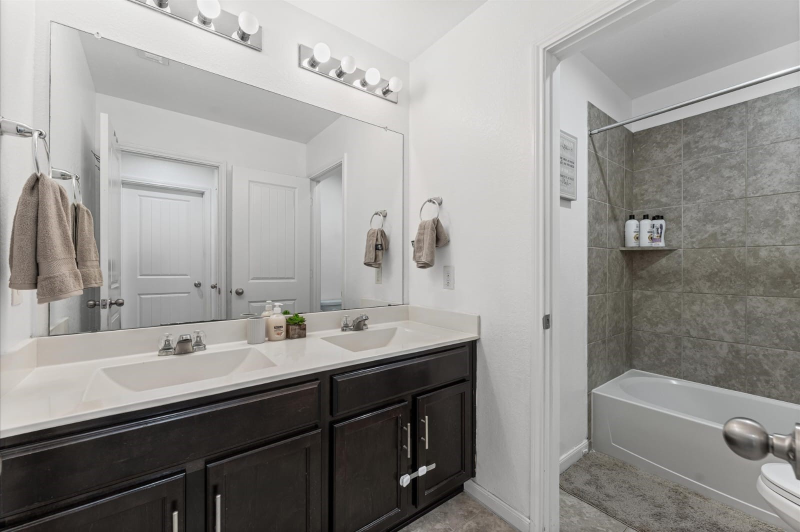 3007 Magellan Ridge Lane Baytown, TX 77521 - Photo 24 of 34 a bathroom with a double vanity sink mirror double and bathtub