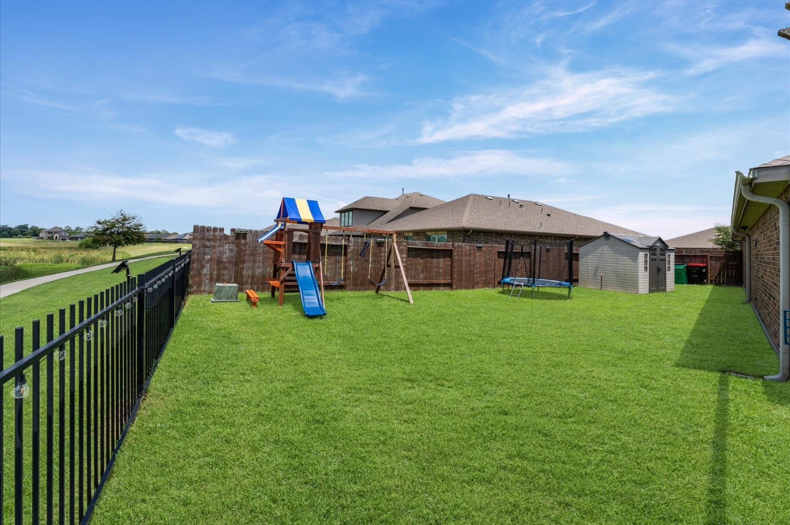 3007 Magellan Ridge Lane Baytown, TX 77521 - Photo 29 of 34 a view of a big house with a big yard and large trees