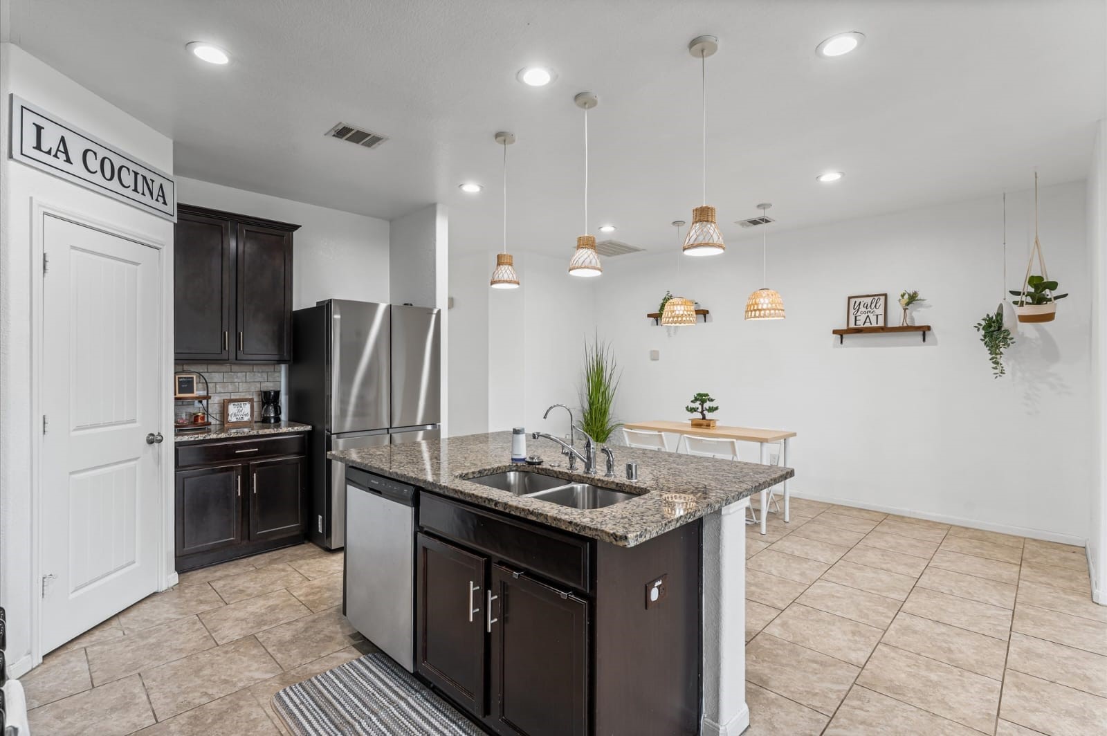 3007 Magellan Ridge Lane Baytown, TX 77521 - Photo 7 of 34 a kitchen with kitchen island granite countertop a sink stove and refrigerator