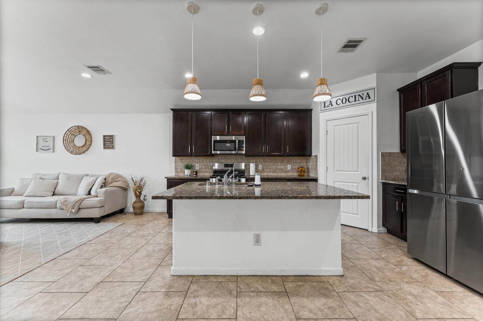 3007 Magellan Ridge Lane Baytown, TX 77521 - Photo 8 of 34 a kitchen with stainless steel appliances granite countertop a sink and a refrigerator