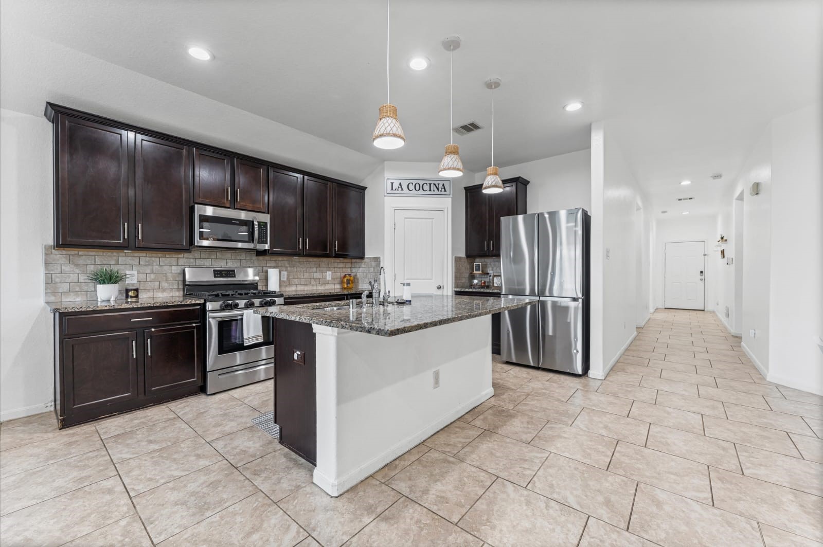 3007 Magellan Ridge Lane Baytown, TX 77521 - Photo 9 of 34 a kitchen with stainless steel appliances granite countertop a refrigerator and a stove top oven
