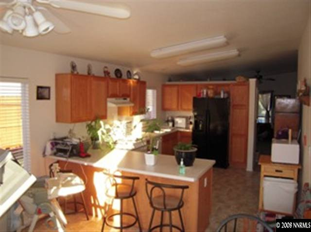 18461 Datewood Court Reno, NV 89508 - Photo 2 of 7 a kitchen with a refrigerator and a stove