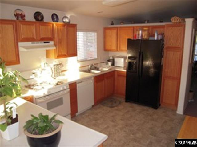 18461 Datewood Court Reno, NV 89508 - Photo 3 of 7 a kitchen with stainless steel appliances granite countertop a refrigerator a sink a stove a microwave and island