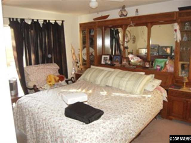 18461 Datewood Court Reno, NV 89508 - Photo 5 of 7 a large bed sitting in a bedroom next to a window