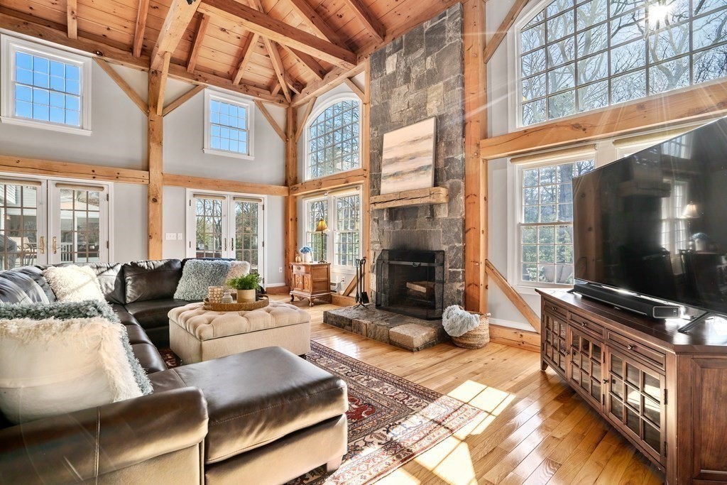 47 Wake Robin Road Sudbury, MA 01776 - Photo 4 of 41 a living room with furniture a flat screen tv and floor to ceiling window