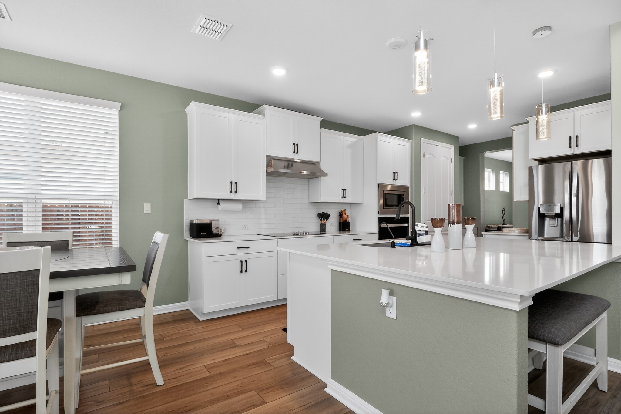114 Bosco Road Hutto, TX 78634 - Photo 33 of 39 Bright white cabinetry and sleek countertops define this modern culinary space.