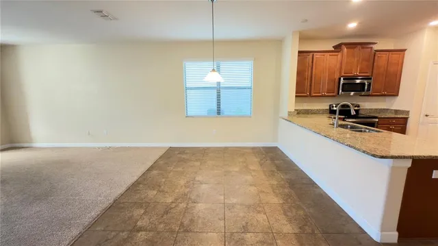 a kitchen with a sink a counter top space appliances and cabinets