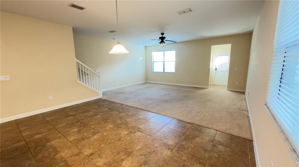 13040 Overstreet Road Windermere, FL 34786 - Photo 17 of 45 a view of a big room with windows and chandelier fan