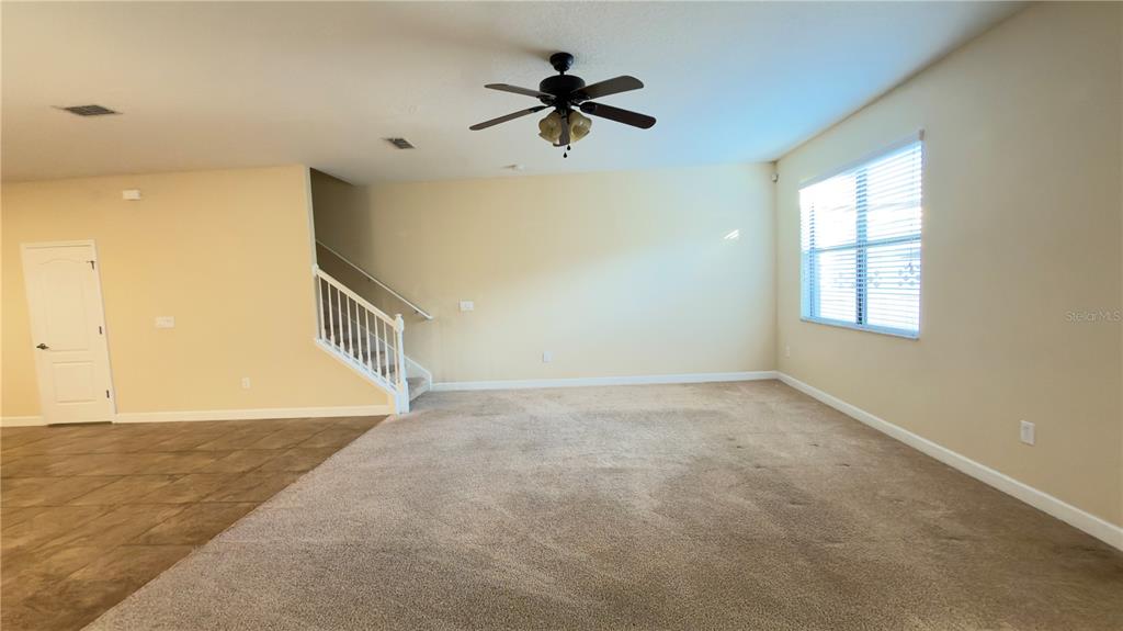 13040 Overstreet Road Windermere, FL 34786 - Photo 18 of 45 an empty room with ceiling fan and windows