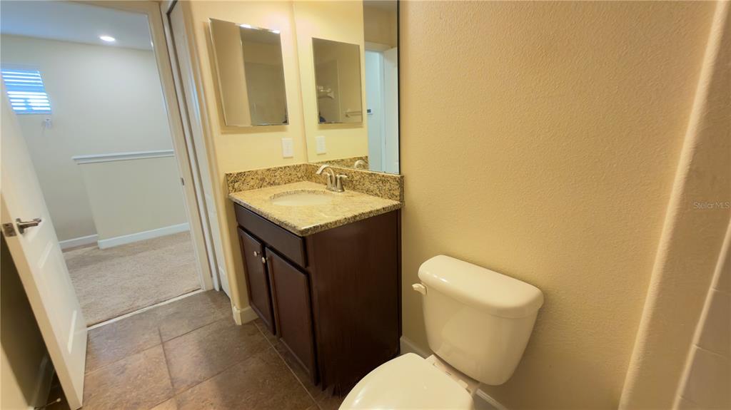 13040 Overstreet Road Windermere, FL 34786 - Photo 26 of 45 a bathroom with a toilet sink and mirror
