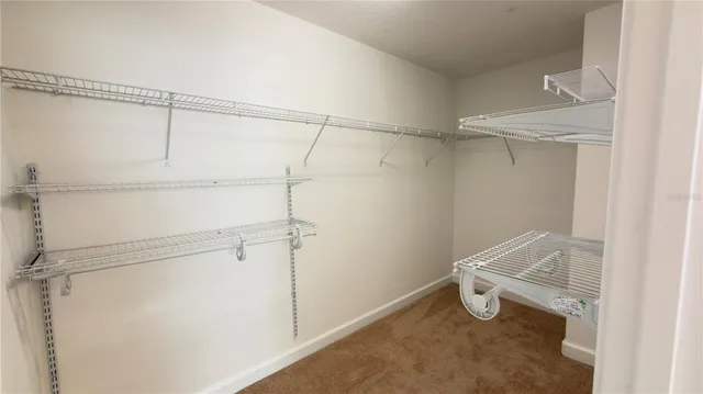 a bathroom with a granite countertop double vanity sink a mirror and a shower