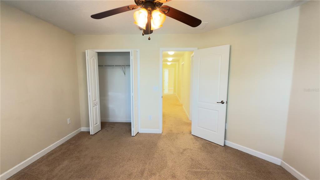 13040 Overstreet Road Windermere, FL 34786 - Photo 34 of 45 an empty room with closet and a chandelier fan