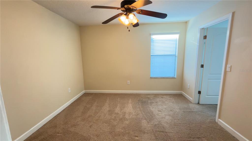 13040 Overstreet Road Windermere, FL 34786 - Photo 35 of 45 an empty room with windows and fan