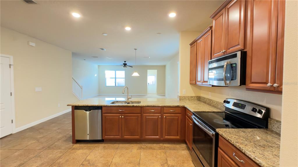 13040 Overstreet Road Windermere, FL 34786 - Photo 8 of 45 a kitchen with stainless steel appliances granite countertop a sink stove and cabinets