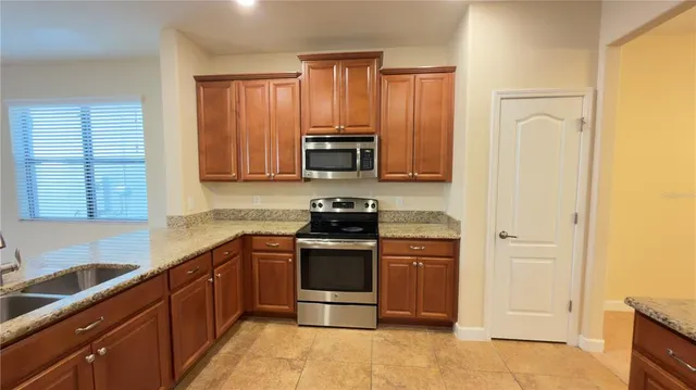 a kitchen with stainless steel appliances granite countertop a stove and a refrigerator